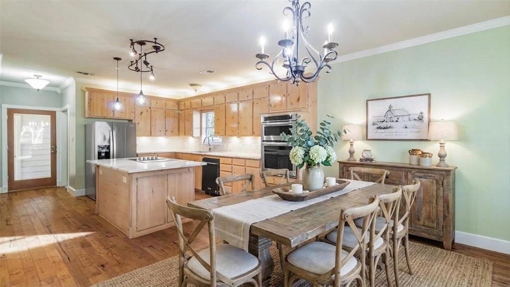 431 Genoa Court Princeton, TX 75407 - Photo 18 of 39 a dining room filled chandelier and wooden floor