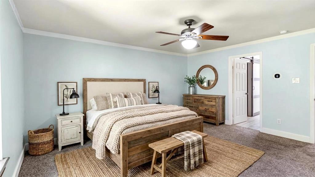 431 Genoa Court Princeton, TX 75407 - Photo 22 of 39 a bedroom with a bed and a chandelier