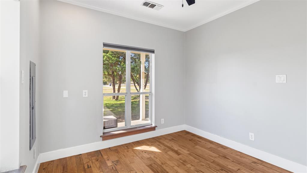 431 Genoa Court Princeton, TX 75407 - Photo 29 of 39 a view of an empty room with wooden floor and a window