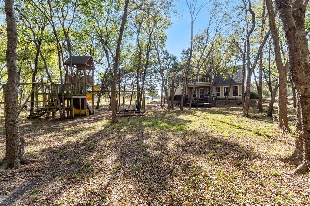 431 Genoa Court Princeton, TX 75407 - Photo 38 of 39 a view of a house with large trees and a yard