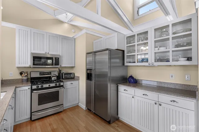 a kitchen with stainless steel appliances a refrigerator stove and microwave