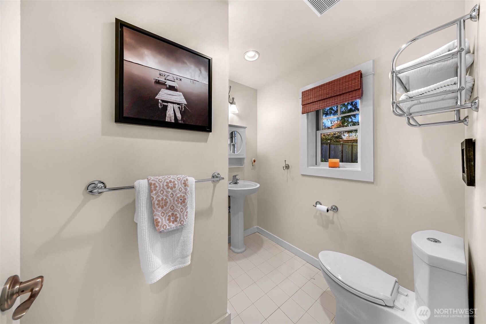 15485 Northeast Peterson Road Keyport, WA 98345 - Photo 22 of 39 a white toilet sitting next to a bathroom sink and a mirror