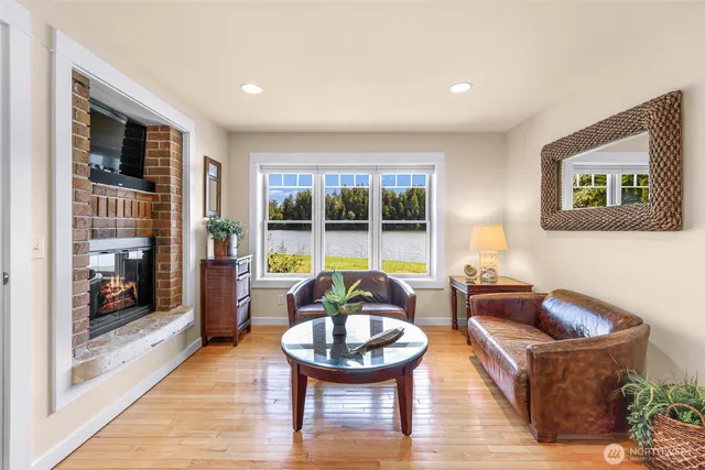 a living room with furniture and a floor to ceiling window