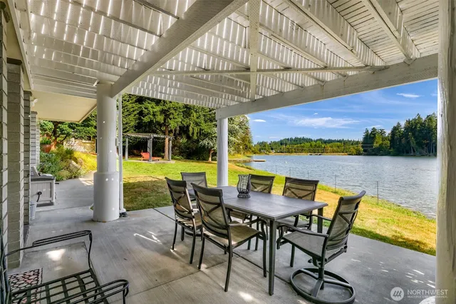 a view of a patio with a table chairs and a swimming pool