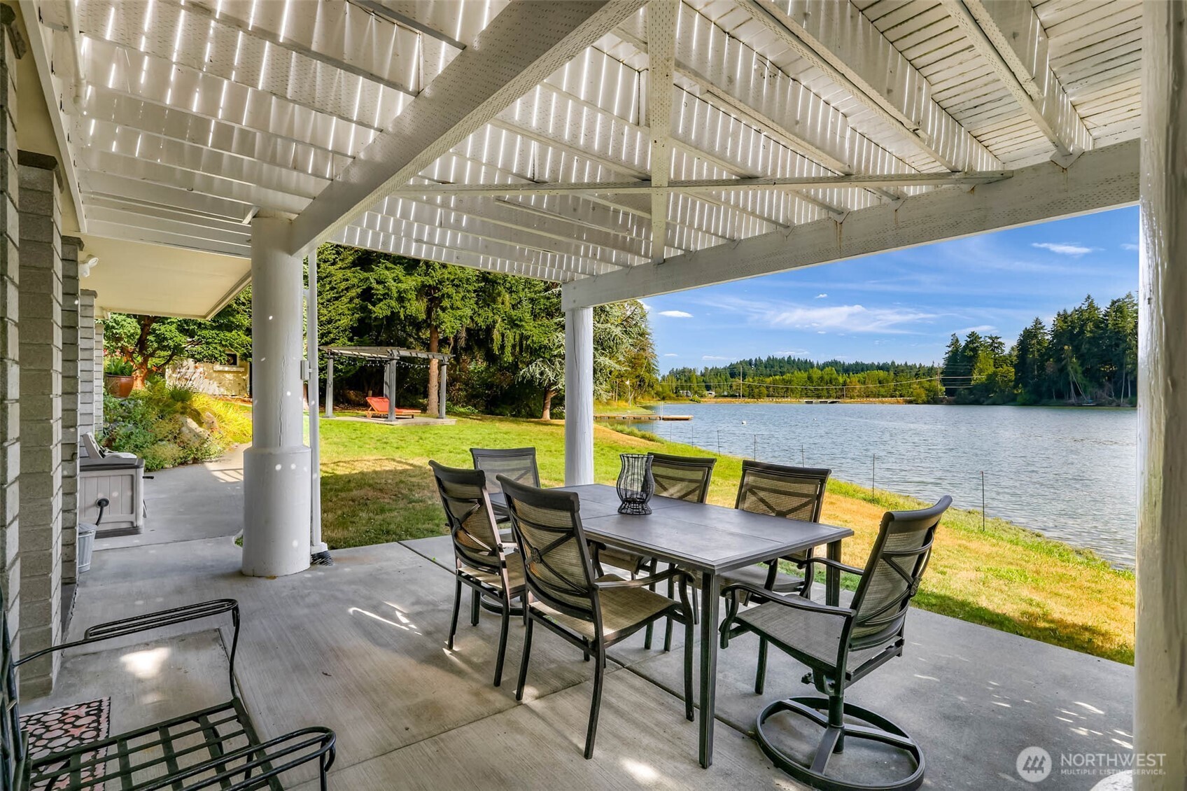 15485 Northeast Peterson Road Keyport, WA 98345 - Photo 27 of 39 a view of a patio with a table chairs and a swimming pool