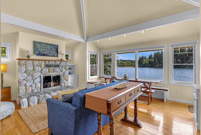 a living room with furniture a table and a fireplace