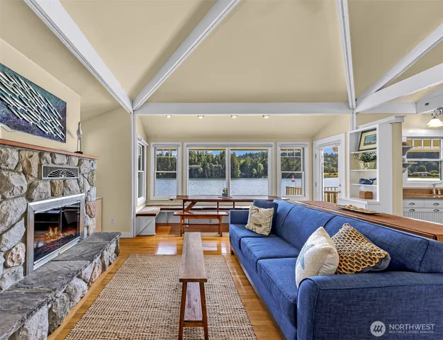a living room with furniture fireplace and a large window