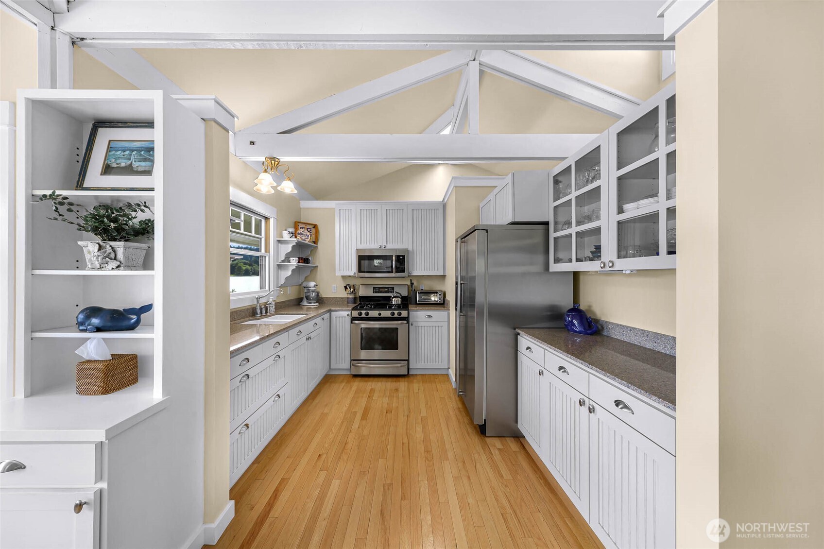 15485 Northeast Peterson Road Keyport, WA 98345 - Photo 10 of 39 a kitchen with stainless steel appliances granite countertop a refrigerator a sink dishwasher a stove and white cabinets with wooden floor