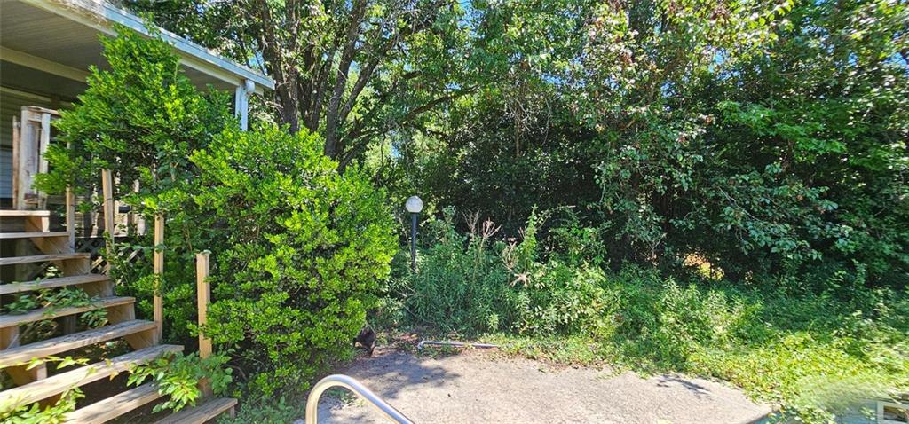 944 Lite-N-Tie Road Macon, GA 31211 - Photo 28 of 36 a backyard of a house with lots of green space and a fountain
