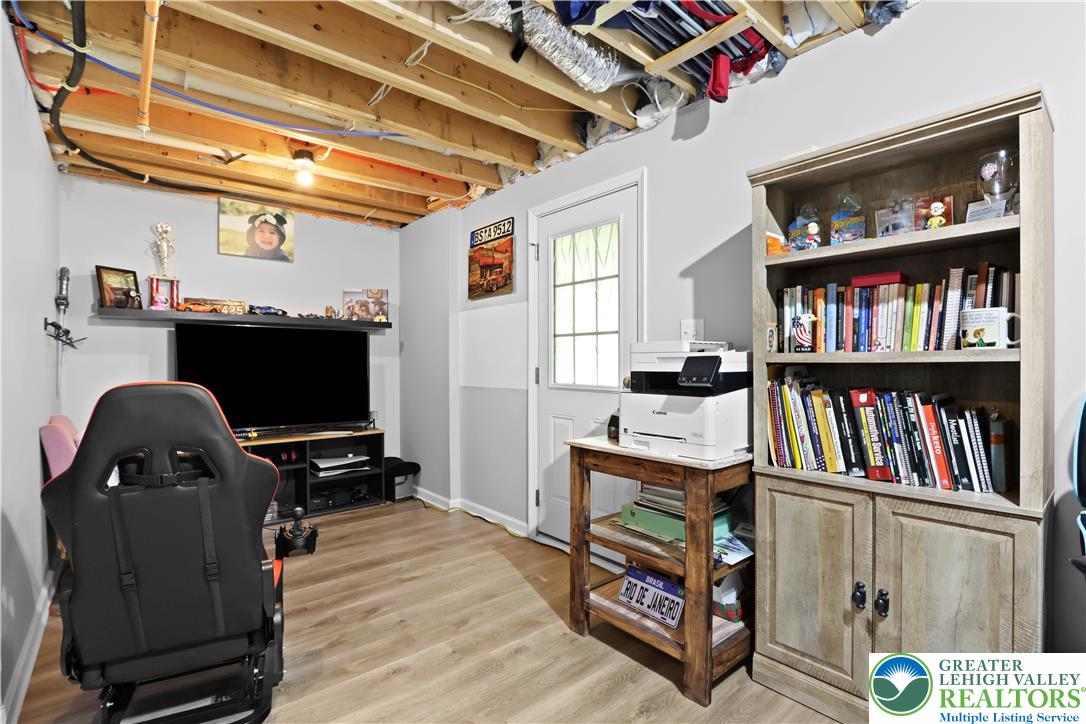 2336 Alex Road Easton, PA 18040 - Photo 23 of 35 An inviting flex space features warm flooring, a light-filled entryway, and an abundance of built-in shelving.