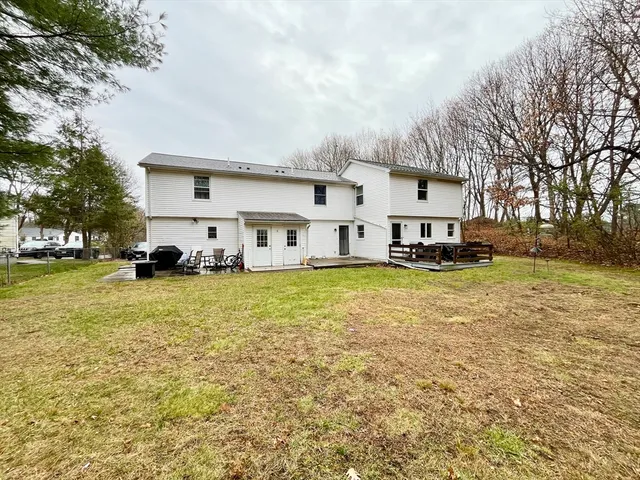 a view of a house with a cars park side of a road