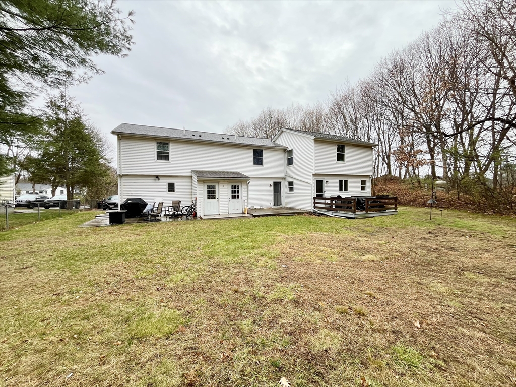11 Jones Landing, Unit B Walpole, MA 02081 - Photo 17 of 18 a front view of residential houses with yard and trees