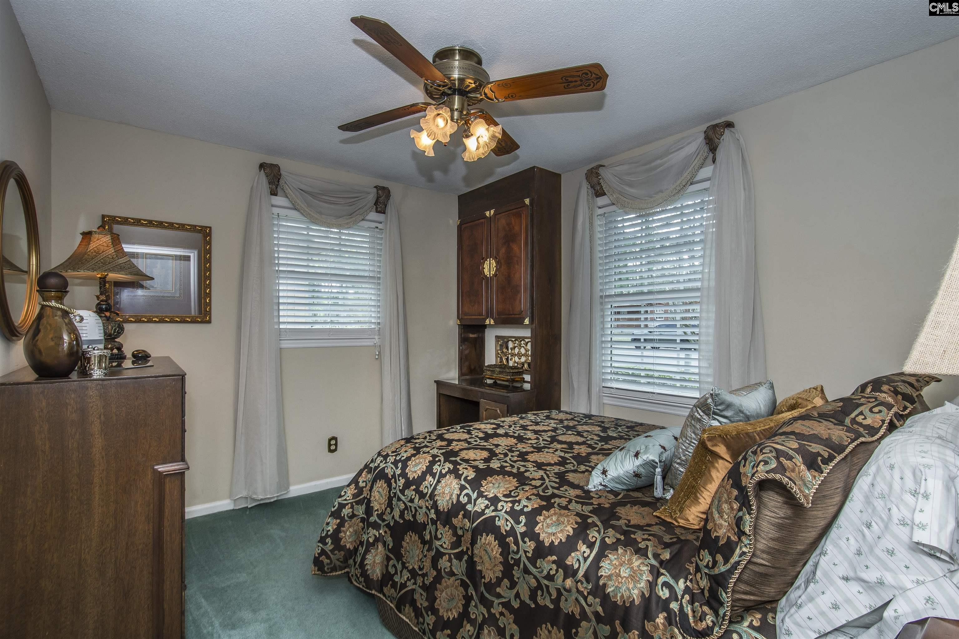 2309 Cunningham Road Columbia, SC 29210 - Photo 39 of 41 a bedroom with a bed and a chandelier
