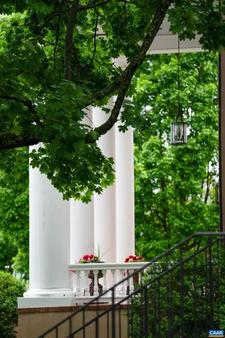 a living room with furniture a fireplace and a chandelier