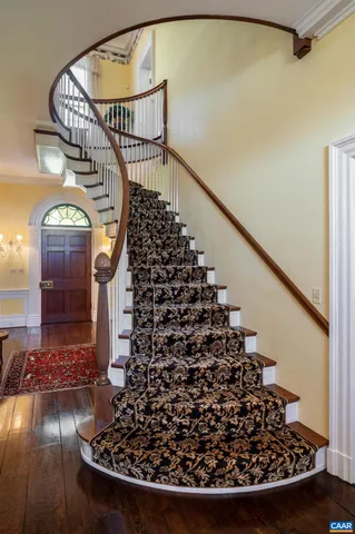 a living room with fireplace furniture and a chandelier