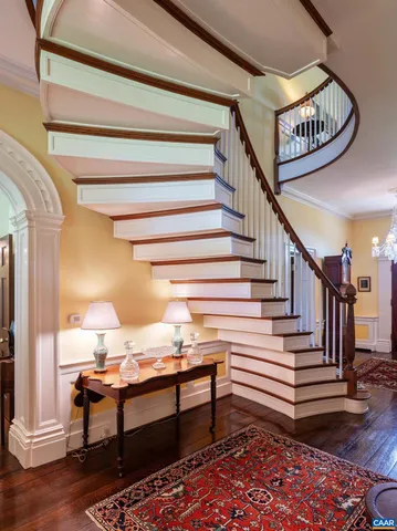 a living room with furniture a fireplace and a large window