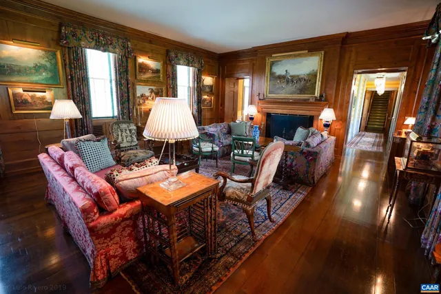 a view of a livingroom with a fireplace and window