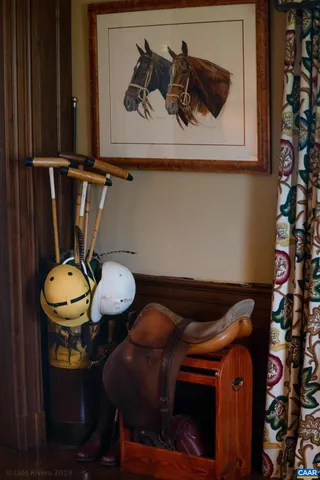 a living room with fireplace furniture and a wooden floor