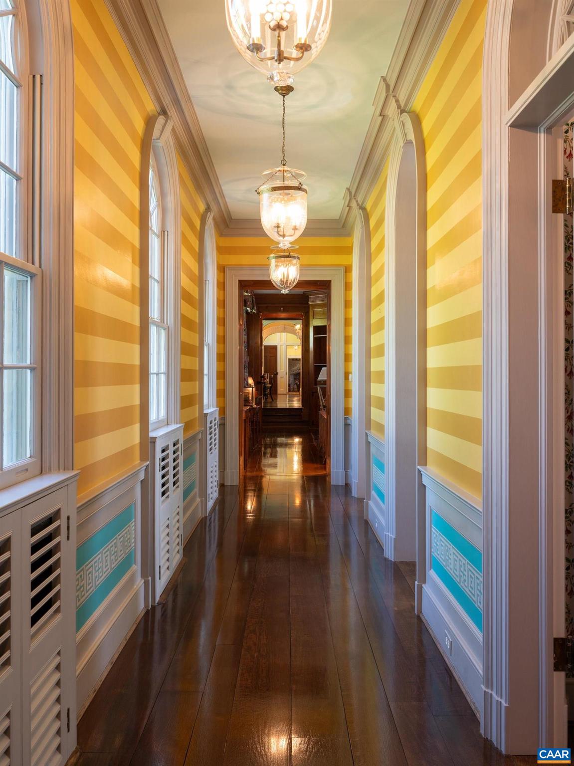 21515 Trappe Road Upperville, VA 20184 - Photo 24 of 75 a hallway with wooden floor windows and a chandelier