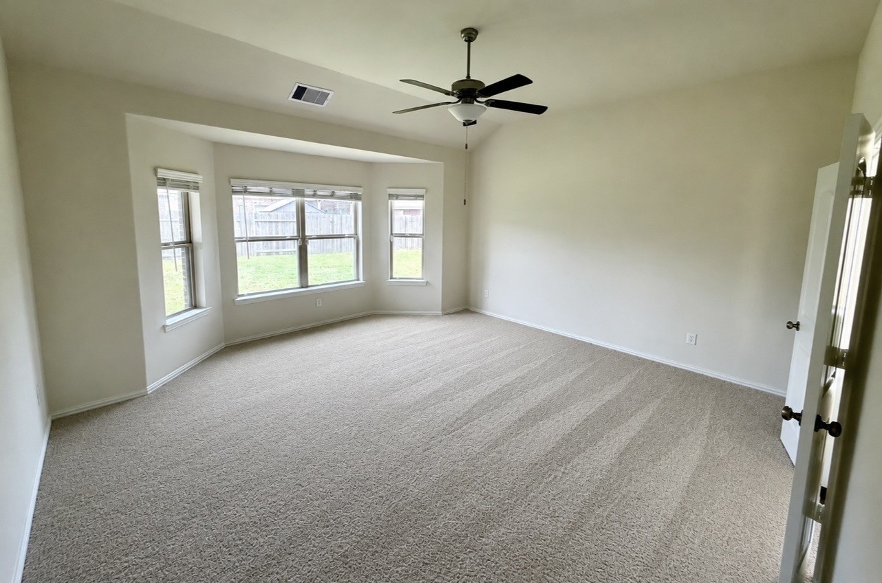 4706 Walnut Willow Ct Spring Spring, TX 77386 - Photo 9 of 17 a view of empty room with a ceiling fan and window