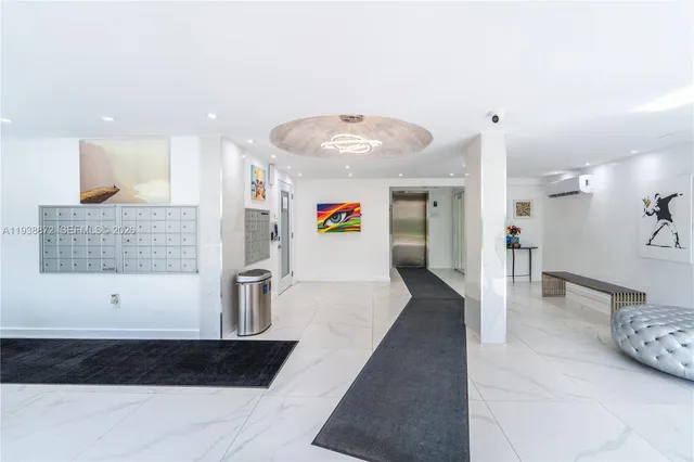a view of lobby with a couch and a chandelier
