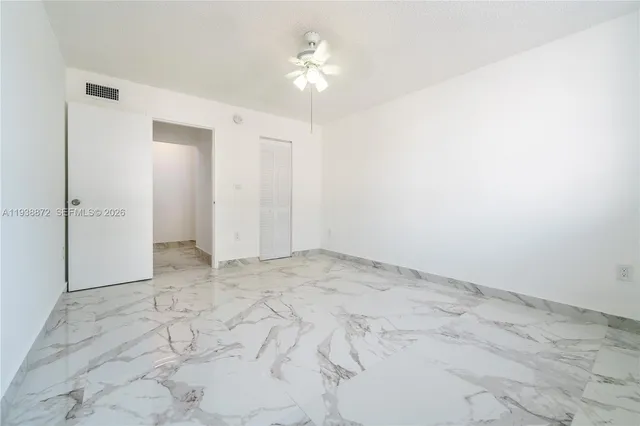 a view of a livingroom with a ceiling fan and entryway