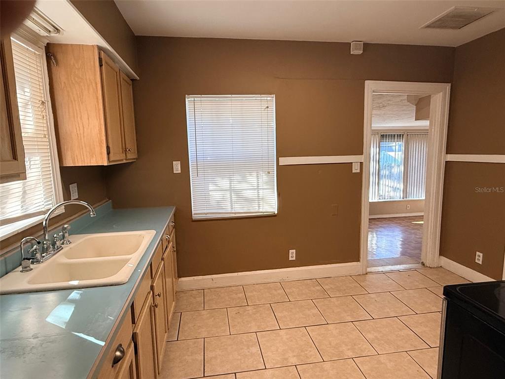 1908 20th Avenue North St. Petersburg, FL 33713 - Photo 13 of 39 a kitchen with a sink cabinets and a stove top oven