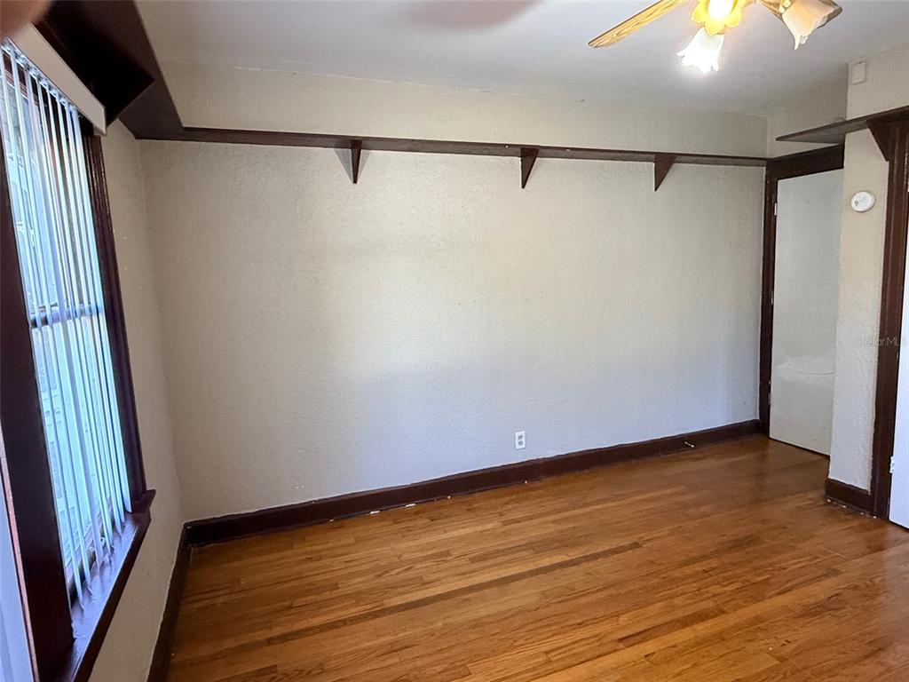 1908 20th Avenue North St. Petersburg, FL 33713 - Photo 15 of 39 a view of an empty room with wooden floor and a chandelier