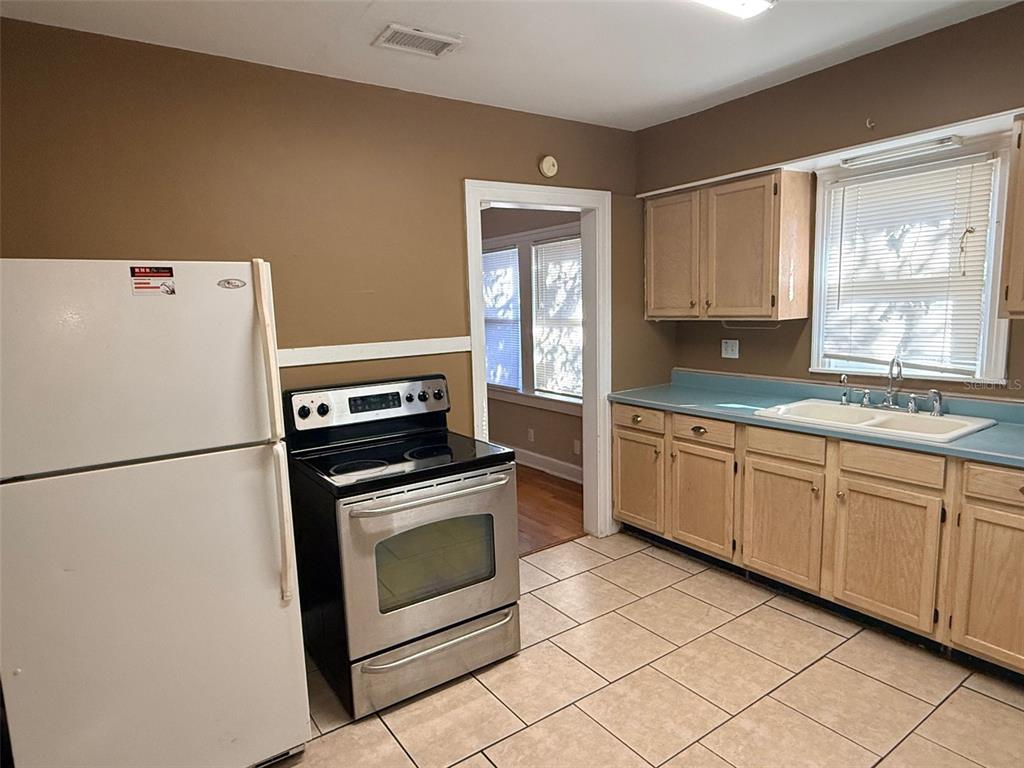 1908 20th Avenue North St. Petersburg, FL 33713 - Photo 10 of 39 a kitchen with granite countertop cabinets stainless steel appliances and a sink
