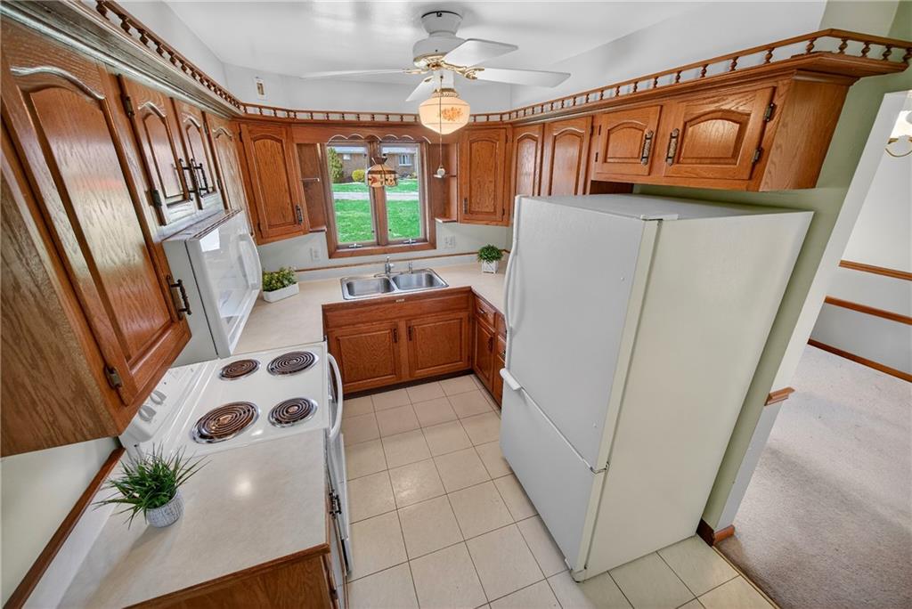 105 Clearview Drive Baden, PA 15005 - Photo 12 of 43 a kitchen with stainless steel appliances a refrigerator a microwave a sink and white cabinets