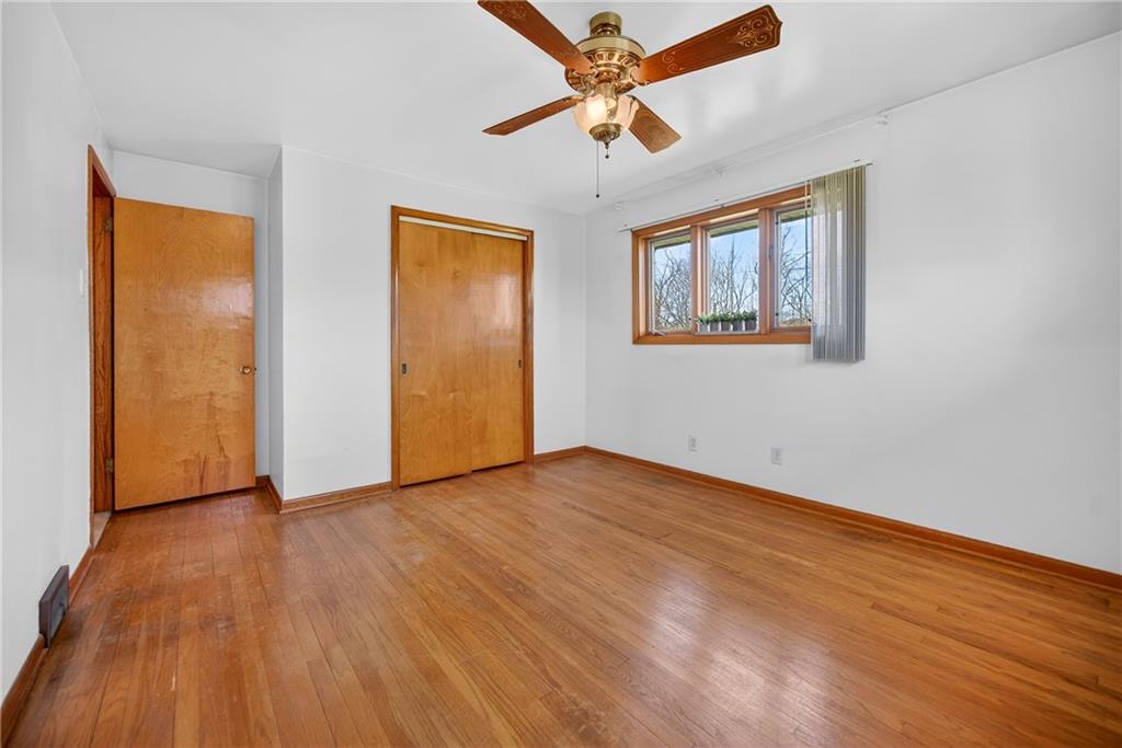 105 Clearview Drive Baden, PA 15005 - Photo 18 of 43 a view of an empty room with wooden floor and a ceiling fan