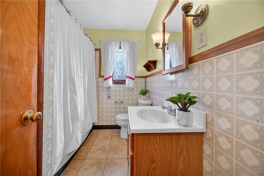 105 Clearview Drive Baden, PA 15005 - Photo 19 of 43 a bathroom with a granite countertop sink a mirror and shower