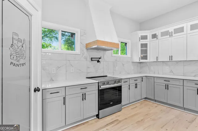 a kitchen with stainless steel appliances granite countertop a stove and a sink