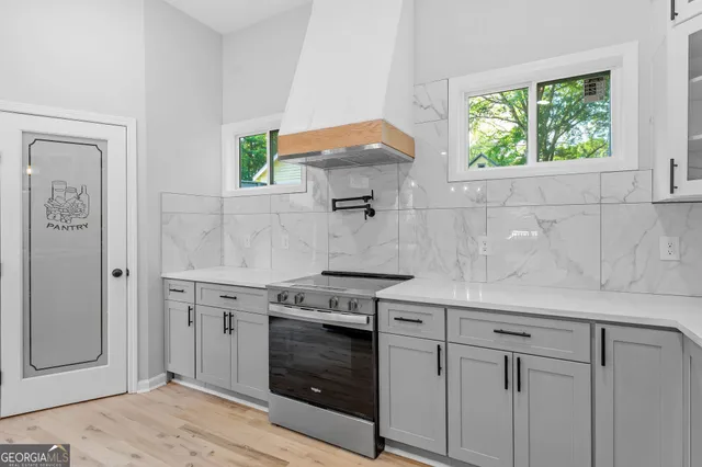 a kitchen with stainless steel appliances white cabinets and a stove
