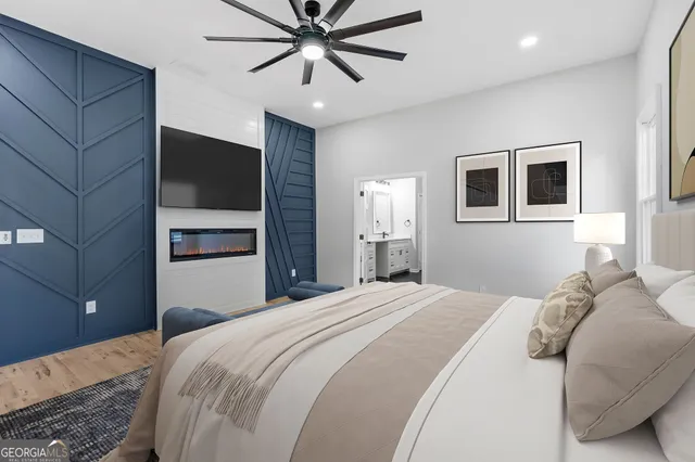 a bedroom with a large bed and a chandelier