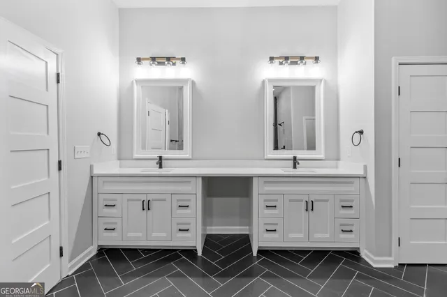 a bathroom with a double vanity sink mirror and