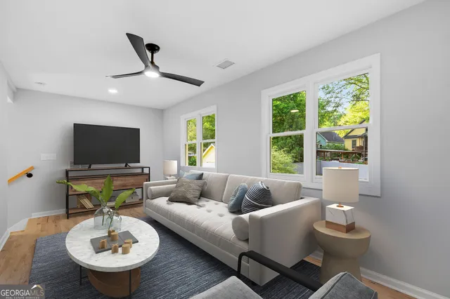 a living room with furniture and a large window