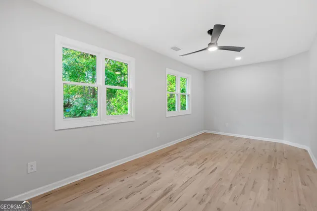 wooden floor in an empty room with a window