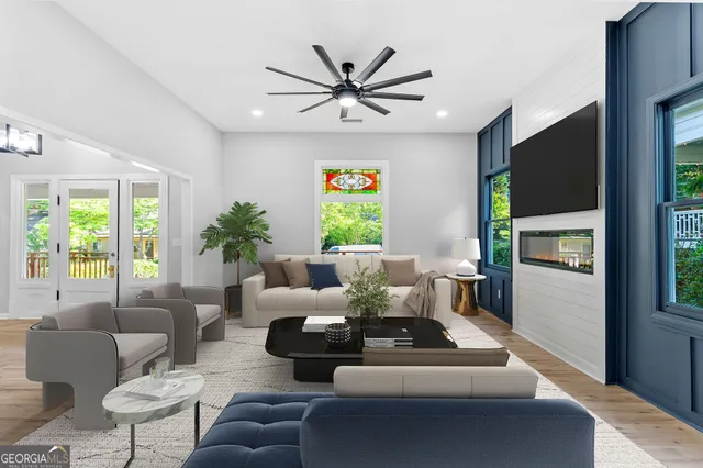 a living room with furniture a window and a flat screen tv