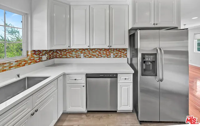 a kitchen with a refrigerator and a sink