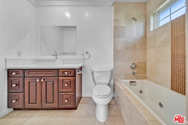 a bathroom with a granite countertop toilet a sink and bathtub