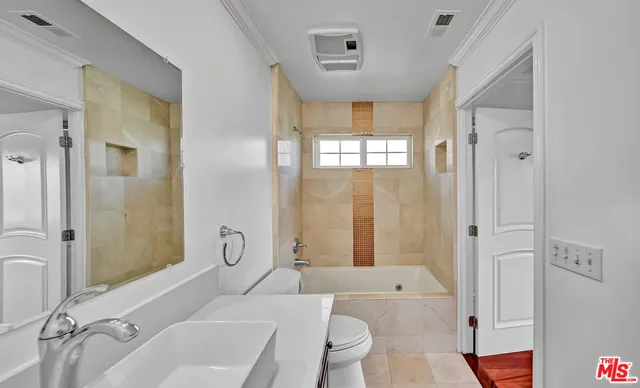 a spacious bathroom with a bathtub shower and toilet