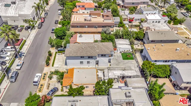 an aerial view of a house with a yard and outdoor seating