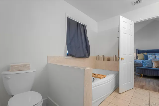 a bathroom with a toilet a sink and tub