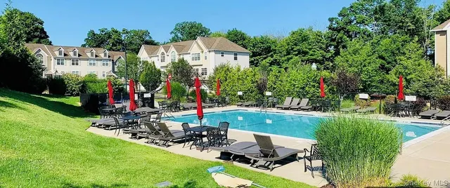a view of house with backyard outdoor seating and garden