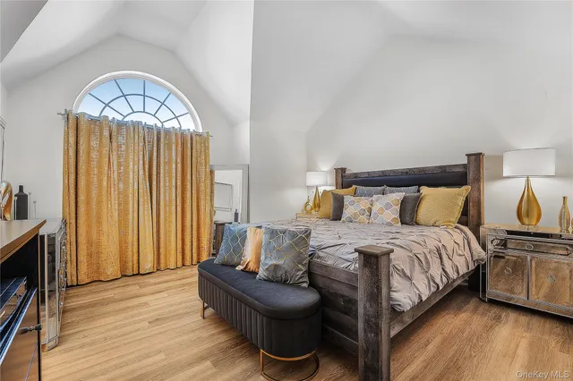 a bedroom with a bed and a chandelier