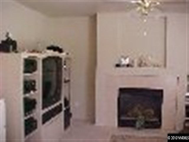 11974 Kernite Street Reno, NV 89506 - Photo 2 of 6 a living room with furniture and a fireplace