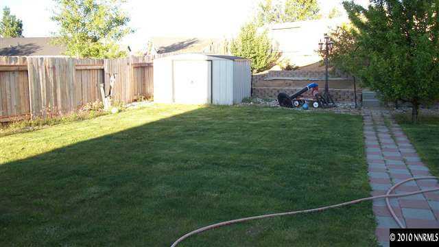 11974 Kernite Street Reno, NV 89506 - Photo 4 of 6 a backyard of a house with lots of green space