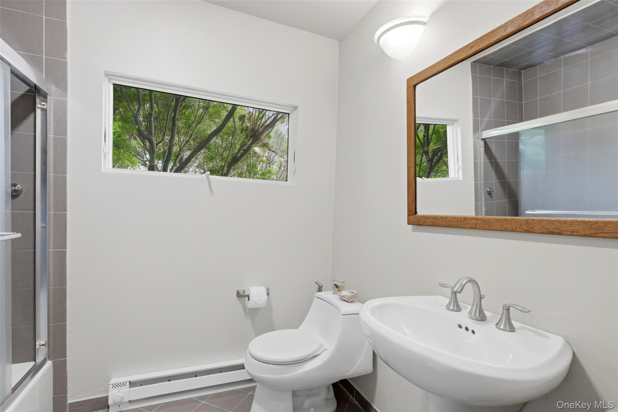 7 Gun Path Setauket, NY 11733 - Photo 26 of 34 a bathroom with a sink a toilet and mirror