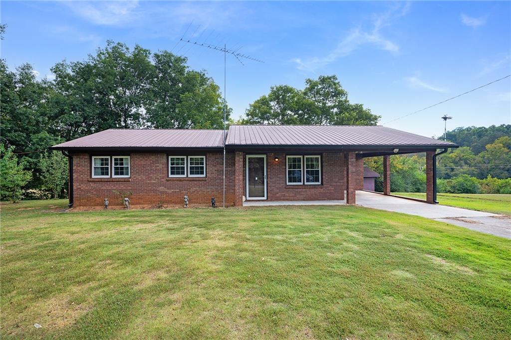 596 Pinhook Road Southeast Fairmount, GA 30139 - Photo 1 of 1 a front view of a house with a garden